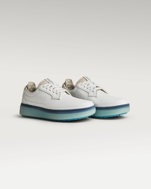 45 degree angled view of white and aqua Beta Derby golf shoe