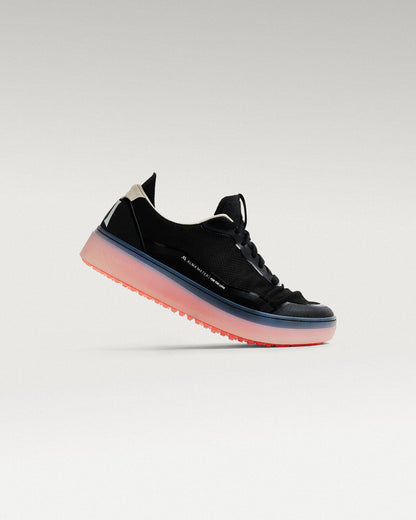 Side view of black and flare Beta Lite golf shoe showing flex