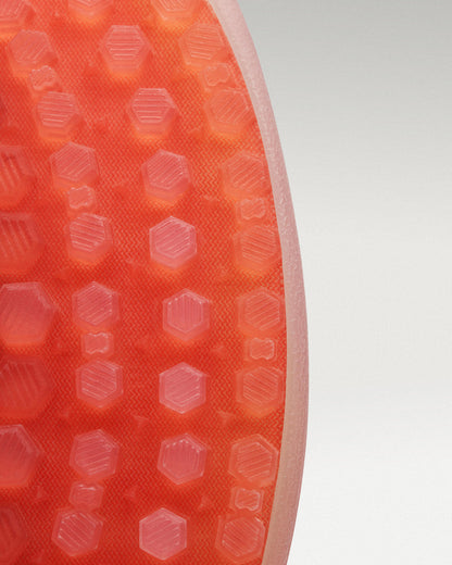 Close up Outsole view of black and flare Beta Lite golf shoe showing traction pattern