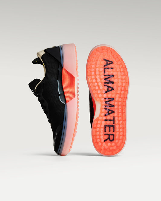 Black and Flare Beta Lite golf shoe with outsole facing forward, showing traction pattern and logo