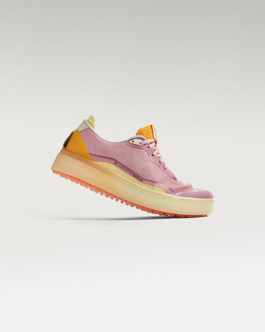 Side view of Lavender-Orange Beta Lite golf shoe, showcasing flex