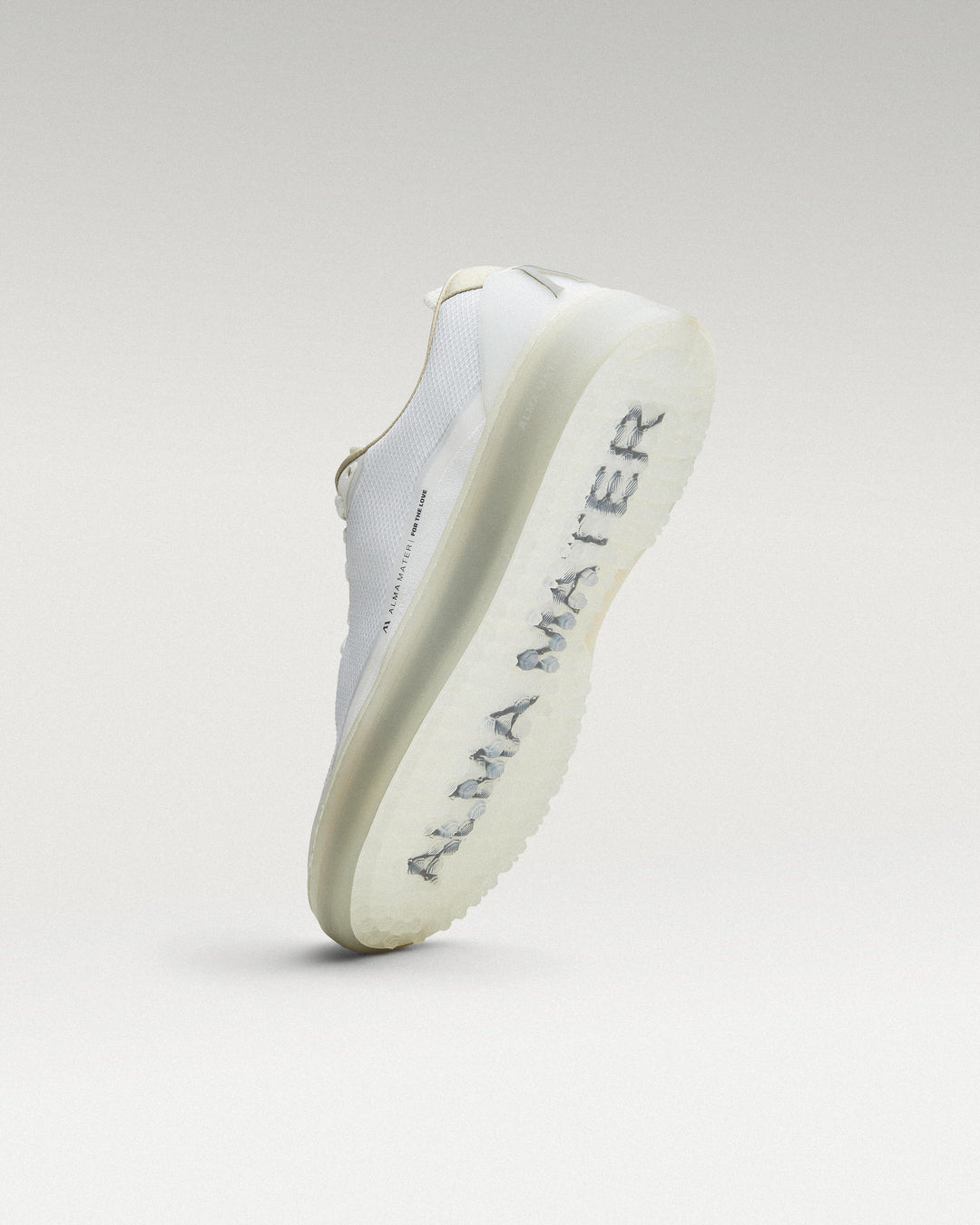 Bottom view of white and grey Beta Lite golf shoe showing traction pattern
