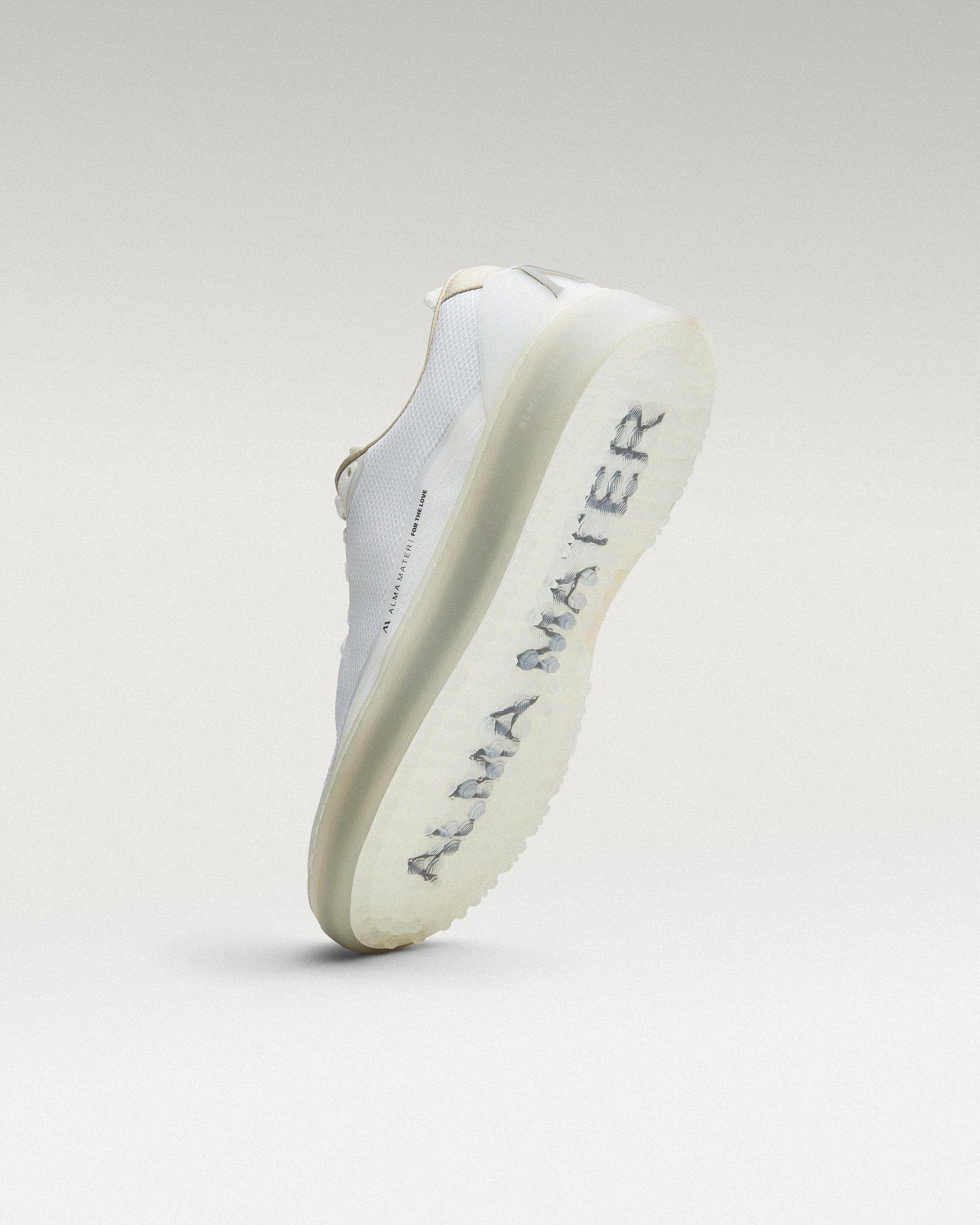 Bottom view of white and grey Beta Lite golf shoe showing traction pattern