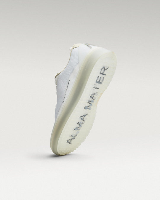 Bottom view of white and grey Beta Lite golf shoe showing traction pattern