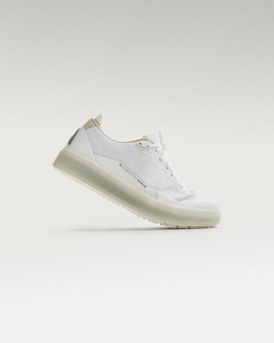 Side view of white and grey Beta Lite golf shoe, showcasing flex