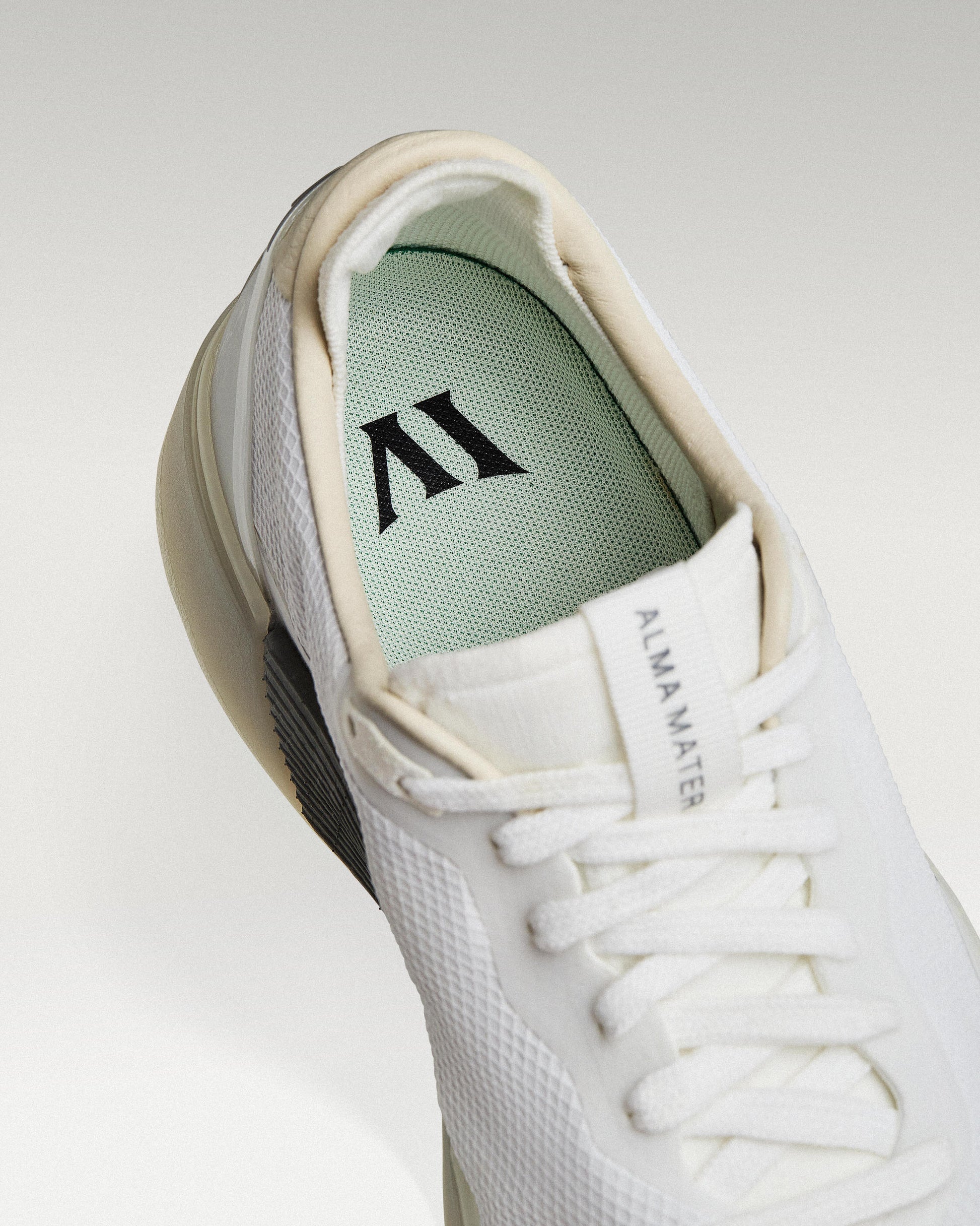 Close-up of interior lining and insole with logo, showcasing floating fit system