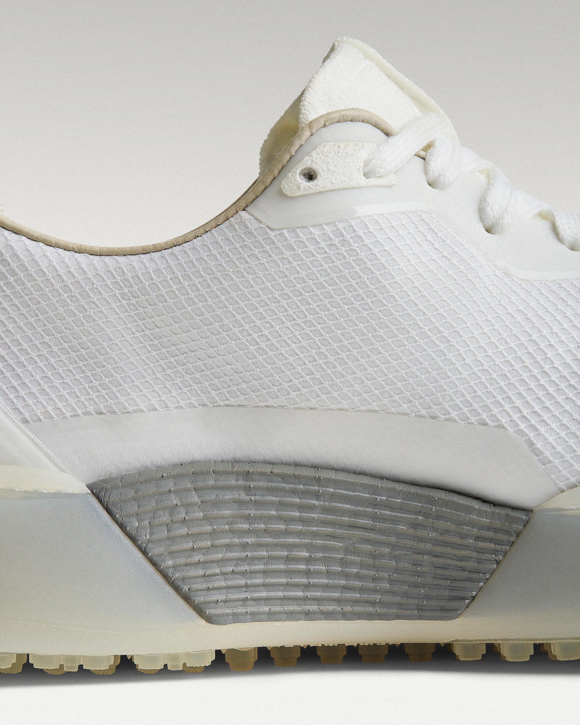 Close-up of side panel showing slipper construction, textured mesh and support structure