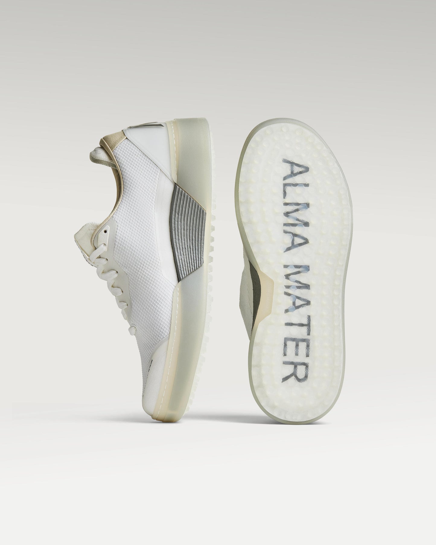 White and grey Beta Lite golf shoe with outsole facing forward, showing traction pattern and logo