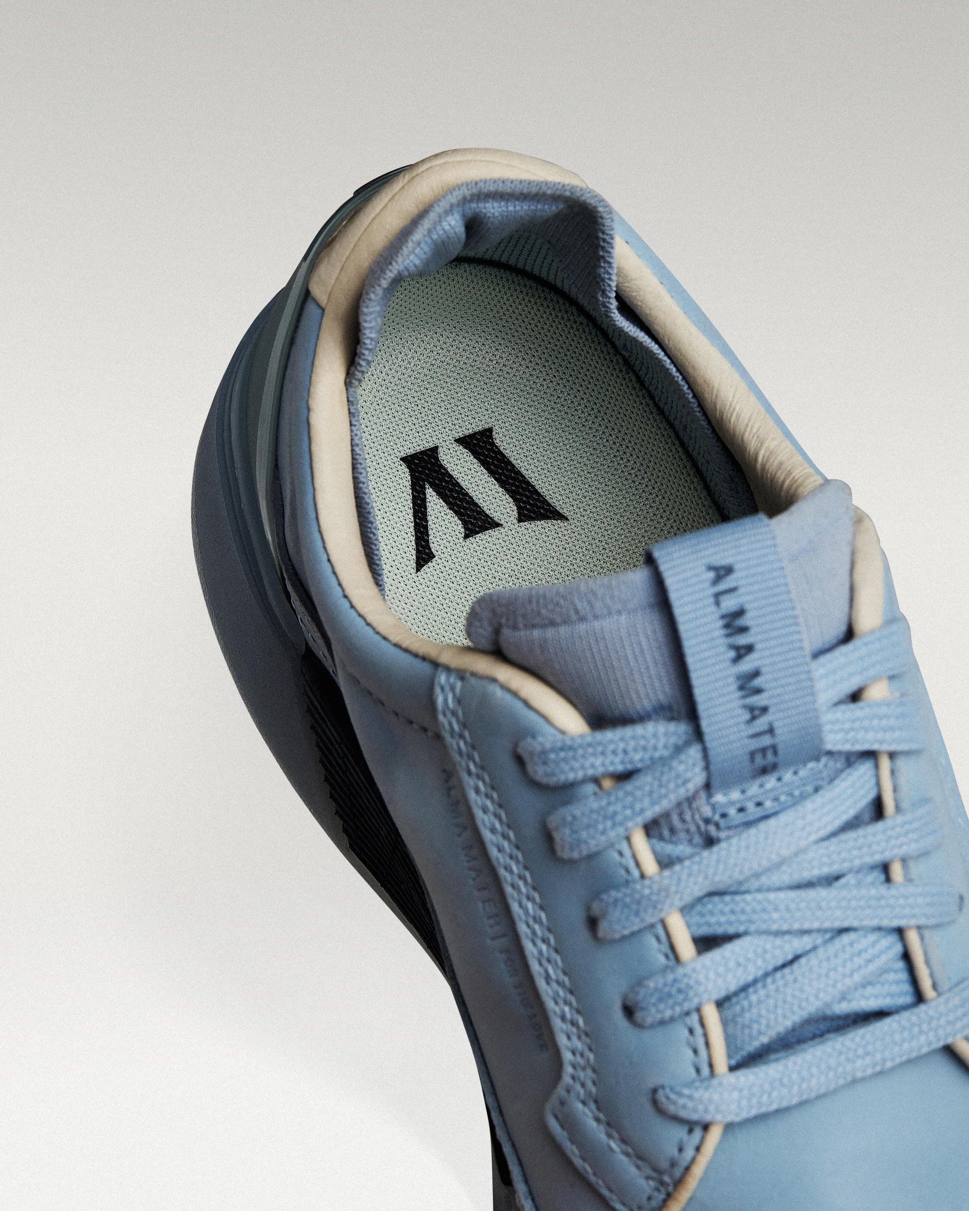 Close-up of interior lining and insole with logo, showcasing floating fit system