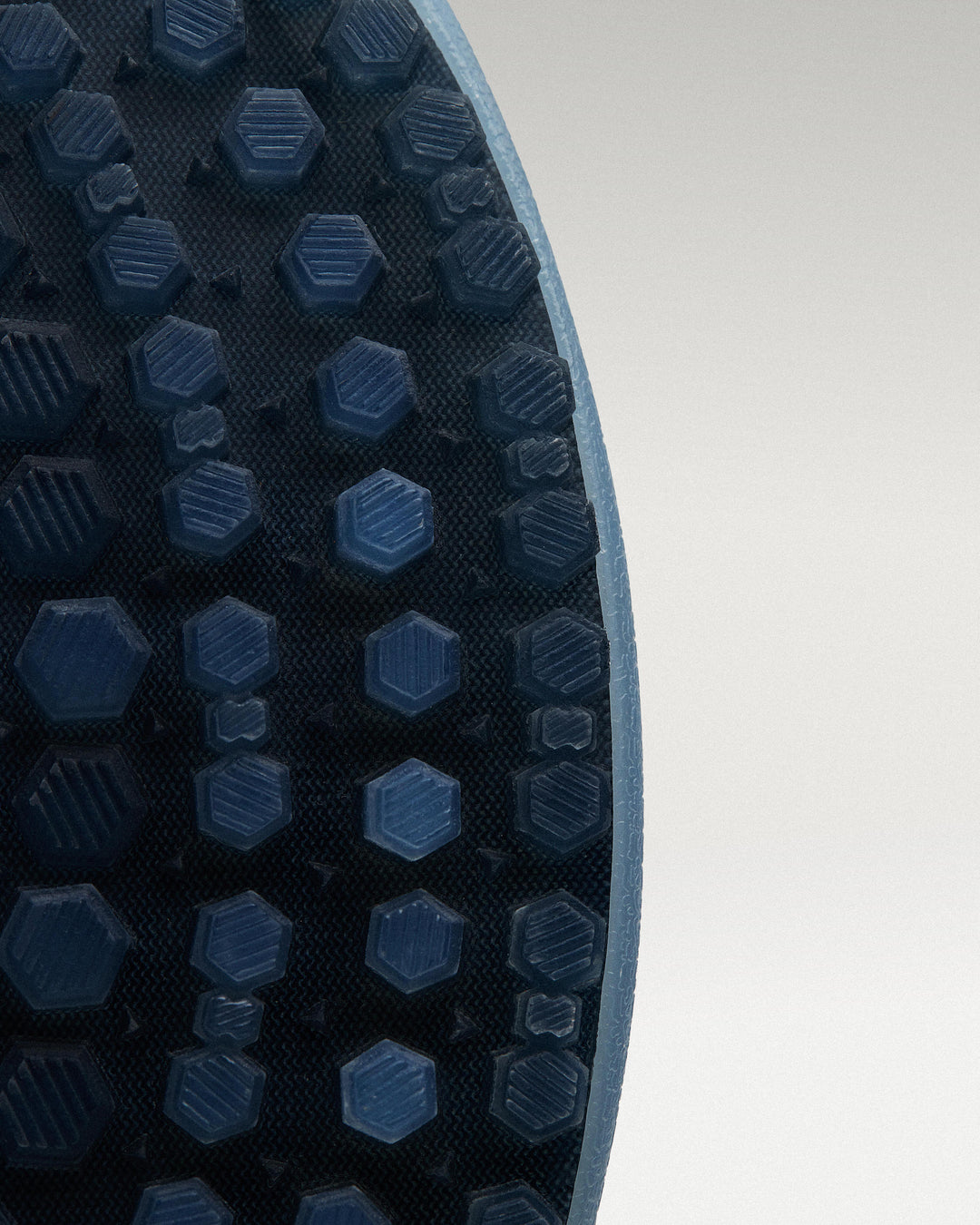 Outsole view of Sky/Navy Beta Longwing golf shoe showing traction pattern