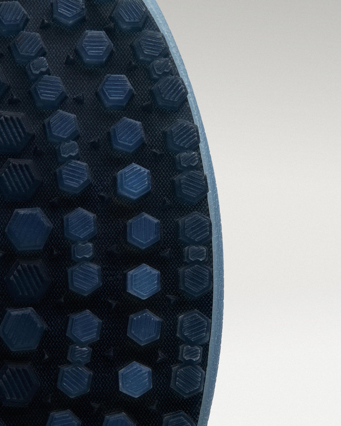 Outsole view of Sky/Navy Beta Longwing golf shoe showing traction pattern
