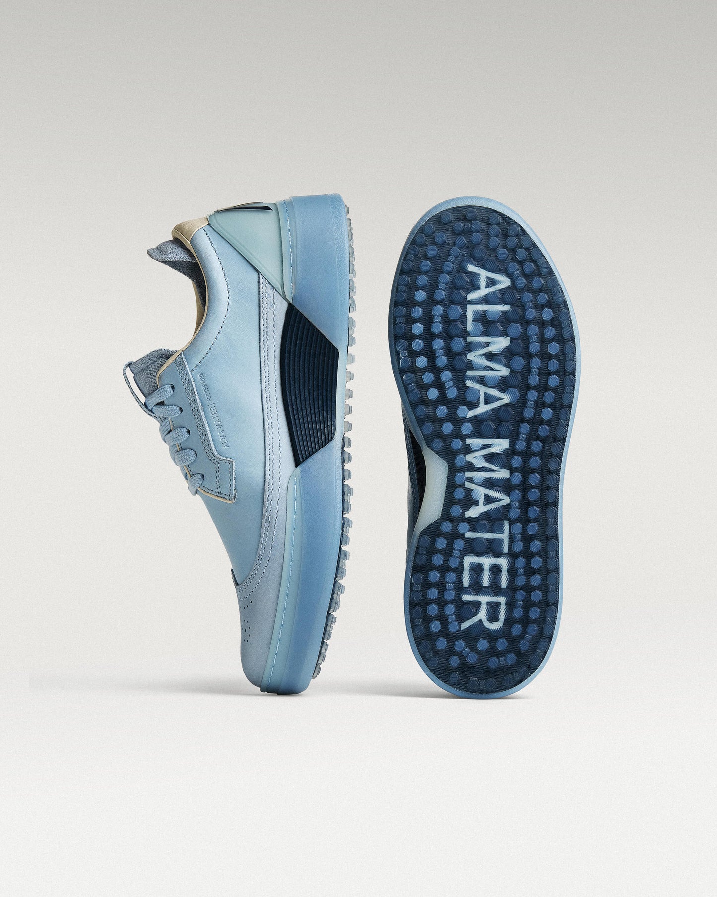 Sky/Navy Beta Longwing golf shoe with outsole facing forward, showing traction pattern and logo