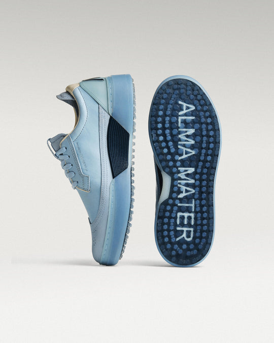 Sky/Navy Beta Longwing golf shoe with outsole facing forward, showing traction pattern and logo