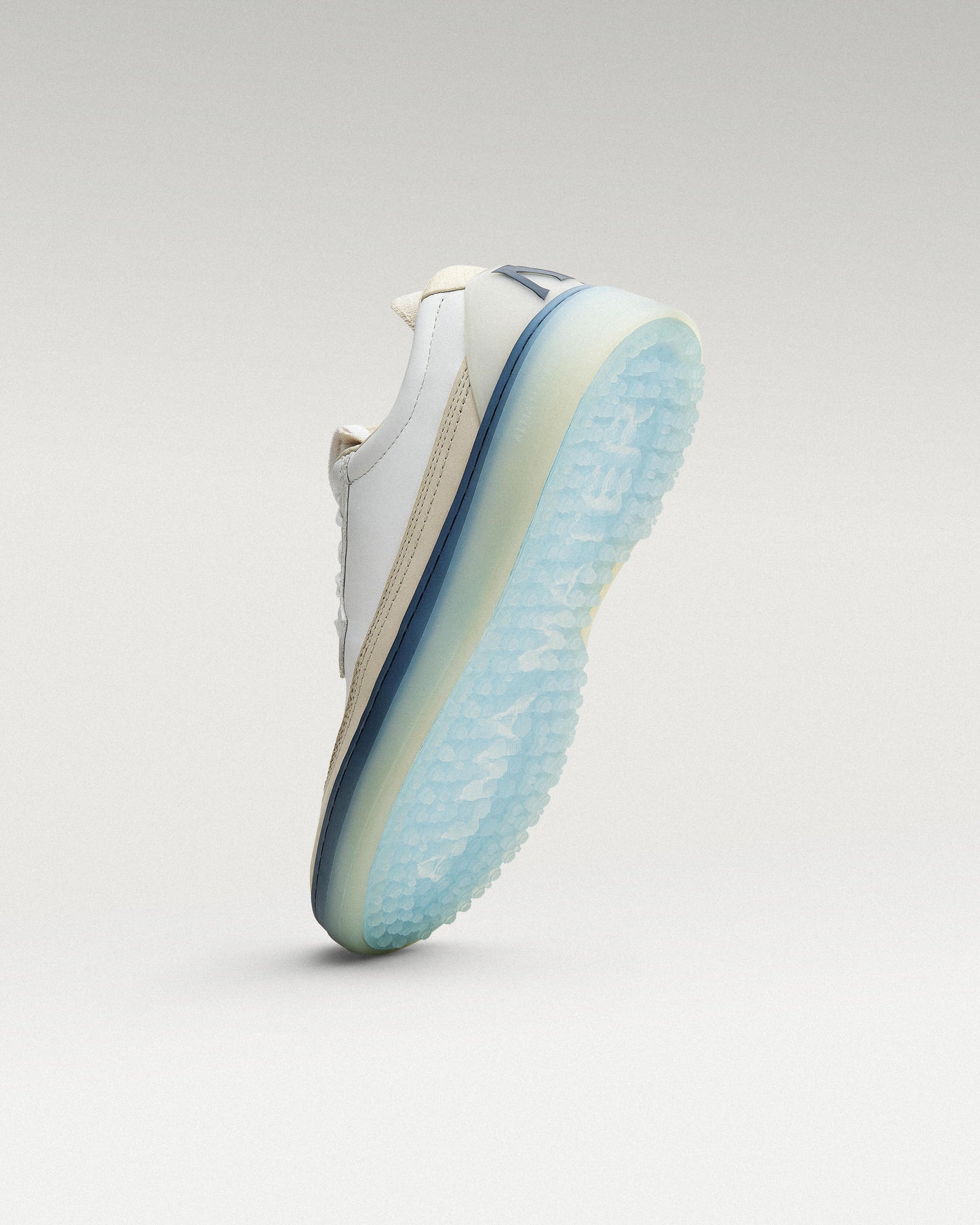 Bottom view of White/Navy Beta Longwing golf shoe showing traction pattern