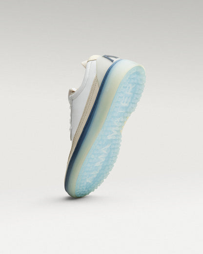 Bottom view of White/Navy Beta Longwing golf shoe showing traction pattern