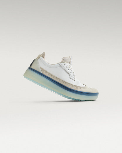 Side view of White/Navy Beta Longwing golf shoe, showcasing flex