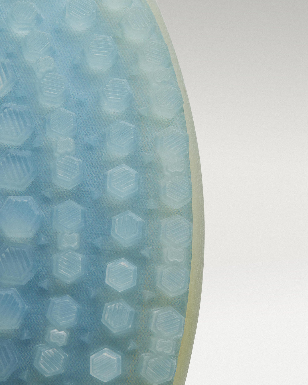Outsole view of White/Navy Beta Longwing golf shoe showing traction pattern