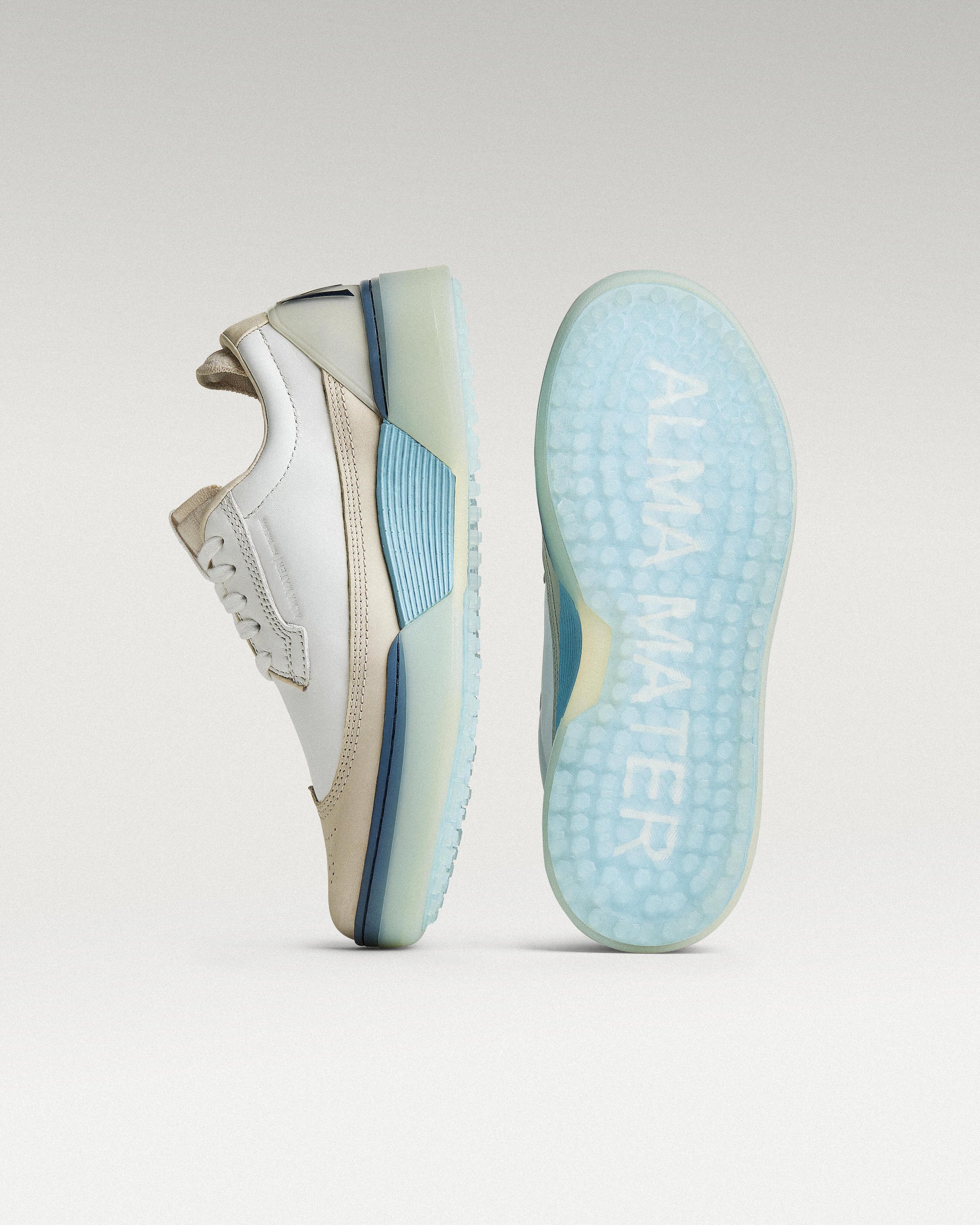 White/Navy Beta Longwing golf shoe with outsole facing forward, showing traction pattern and logo