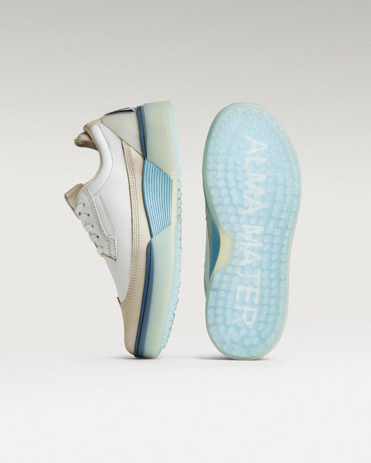 White/Navy Beta Longwing golf shoe with outsole facing forward, showing traction pattern and logo