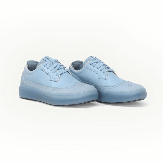 Pair of light blue Beta Longwing golf shoes on a white background