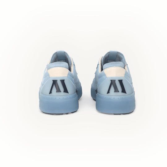 Pair of light blue Beta Longwing golf shoes with a Alma Mater logo on the back on a white background