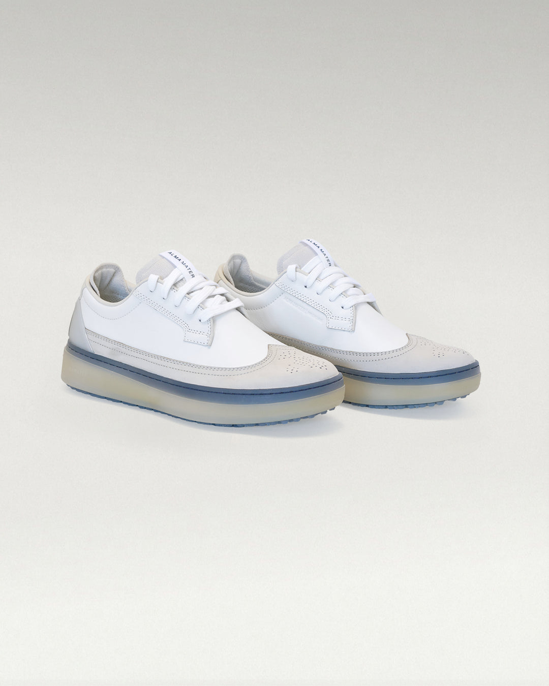 Angled view of white and navy Member Longwing PGA sneakers