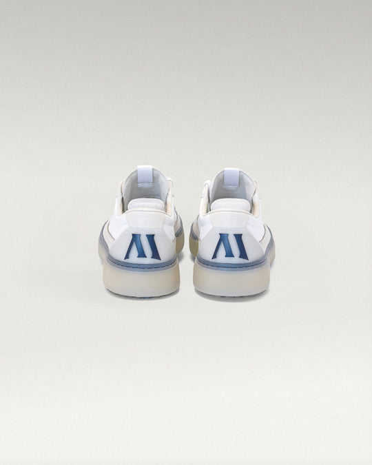 Back view of white and navy Member Longwing PGA sneakers with heel logo detail