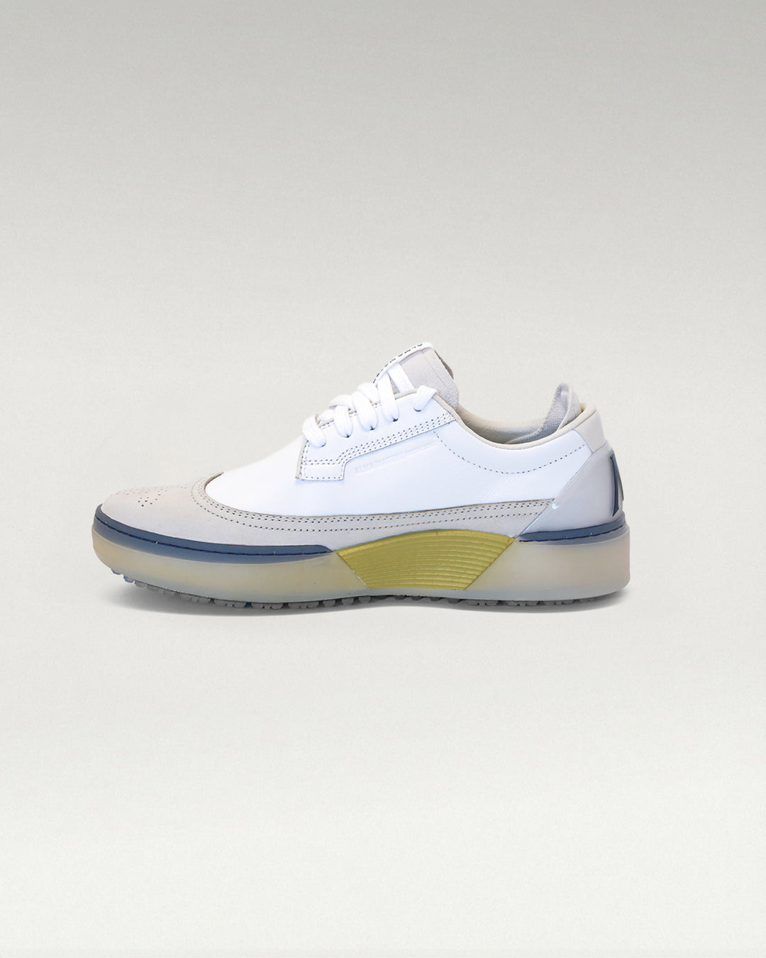 Medial side view of white and navy Member Longwing PGA sneaker