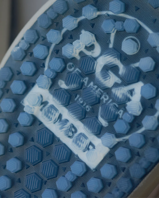 Close-up of a blue textured sole with a PGA of America Logo