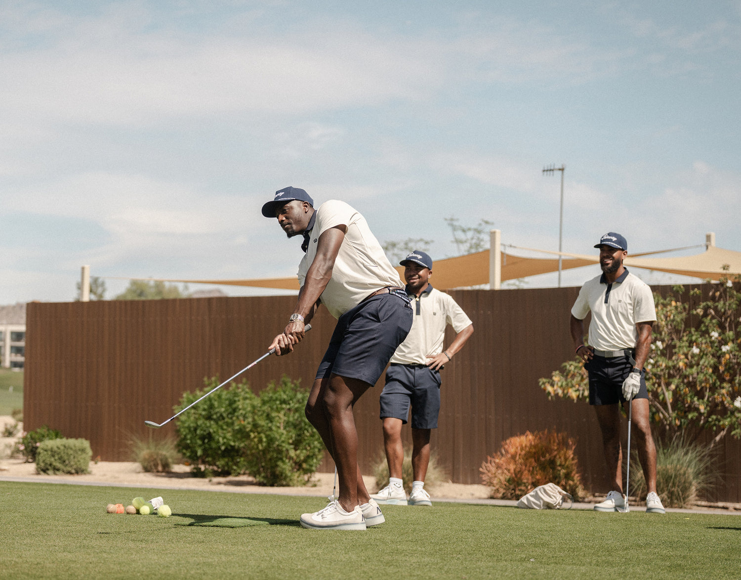 Three men playing golf on a course wearing Beta Longwing