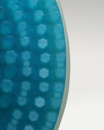 Outsole view of white and aqua Beta Derby golf shoe showing traction pattern
