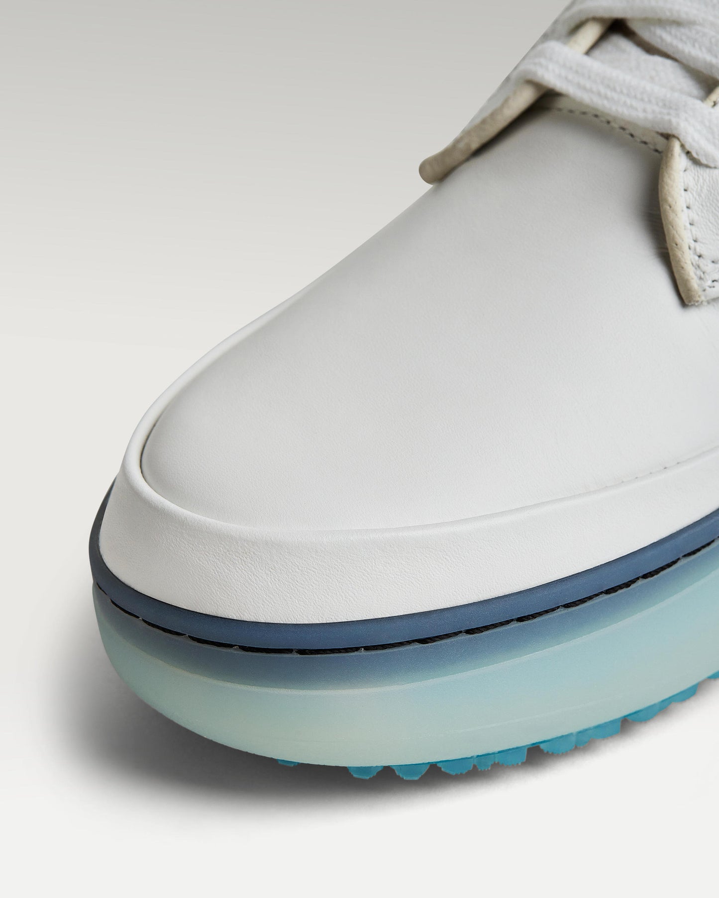 Close-up of white leather upper and toe box detail on Beta Derby golf shoe
