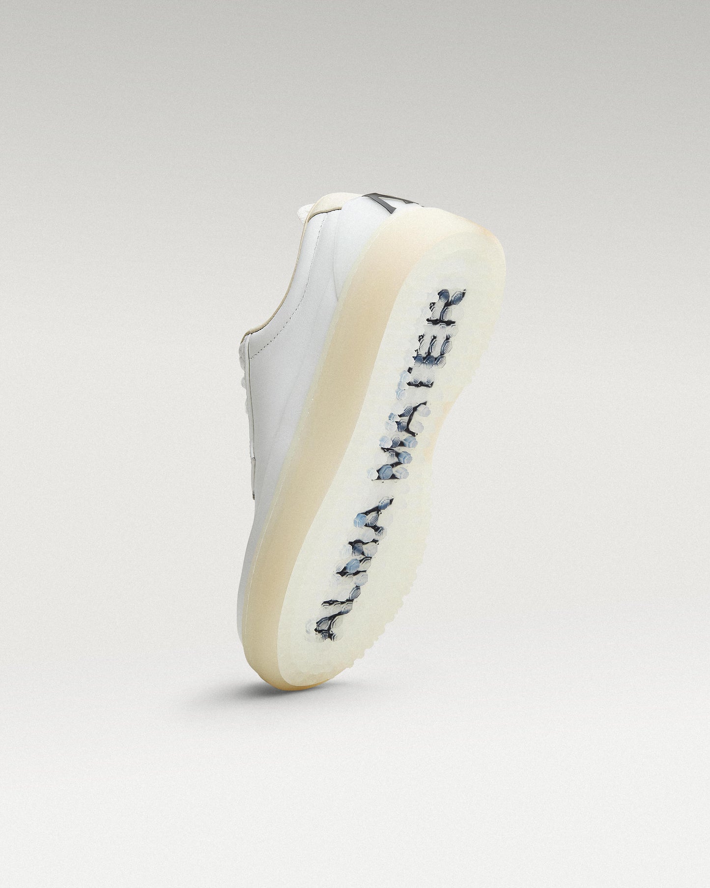 Bottom view of white and white Beta Derby golf shoe showing traction pattern
