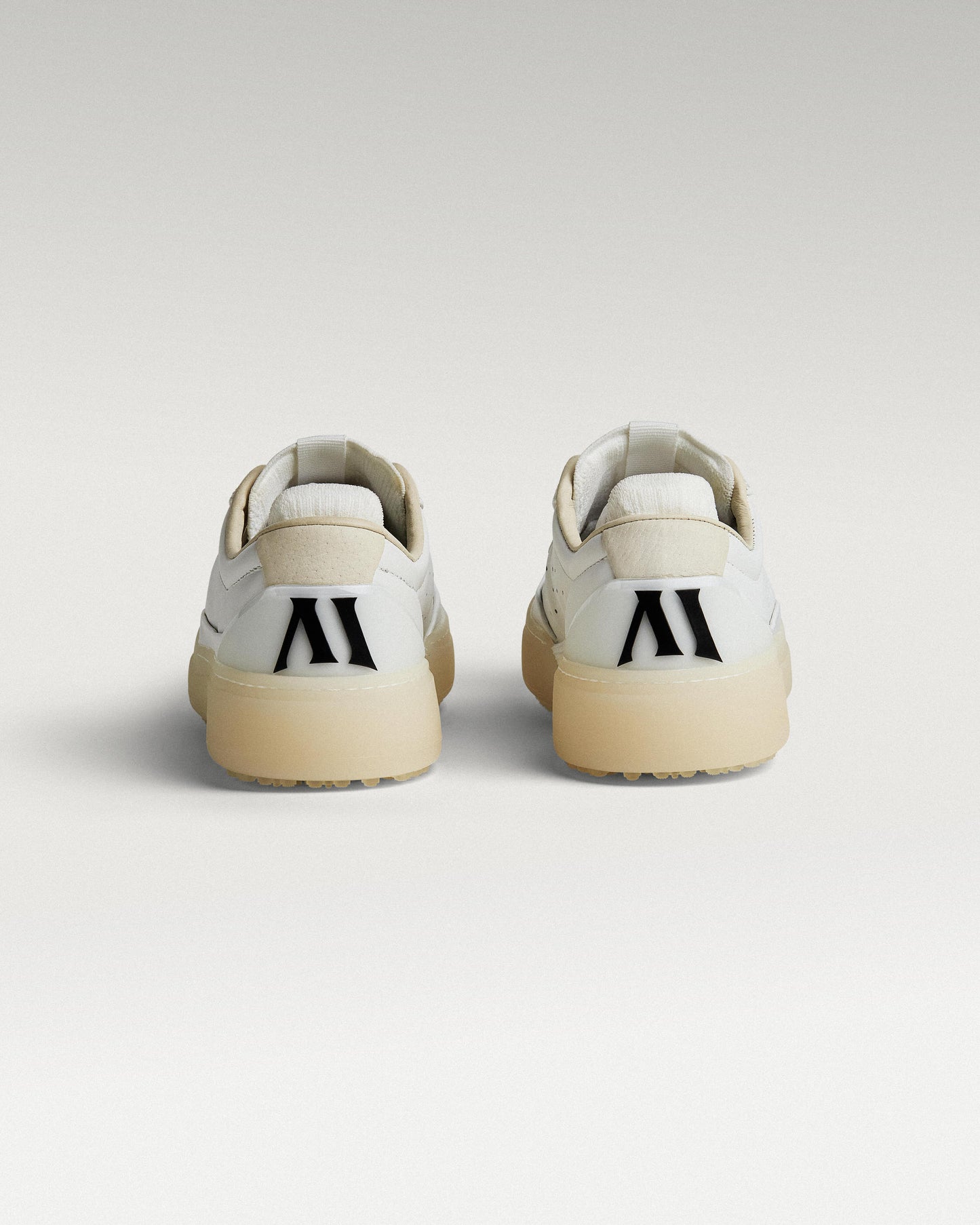 Back view of white and white Beta Derby golf shoes with heel detail