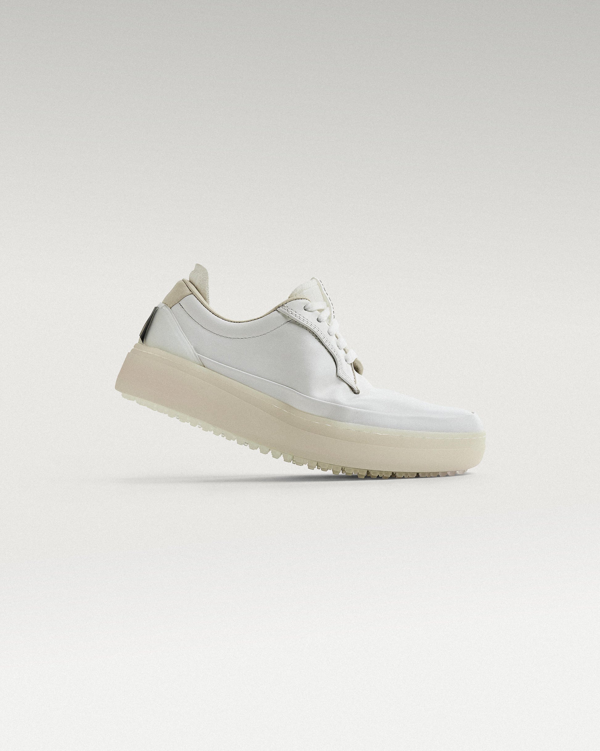 Side view of white and white Beta Derby golf shoe, showcasing flex