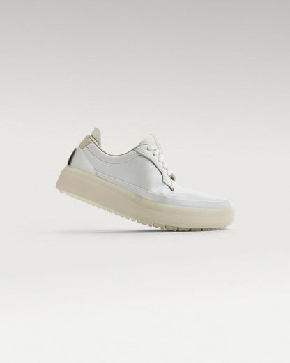 Side view of white and white Beta Derby golf shoe, showcasing flex