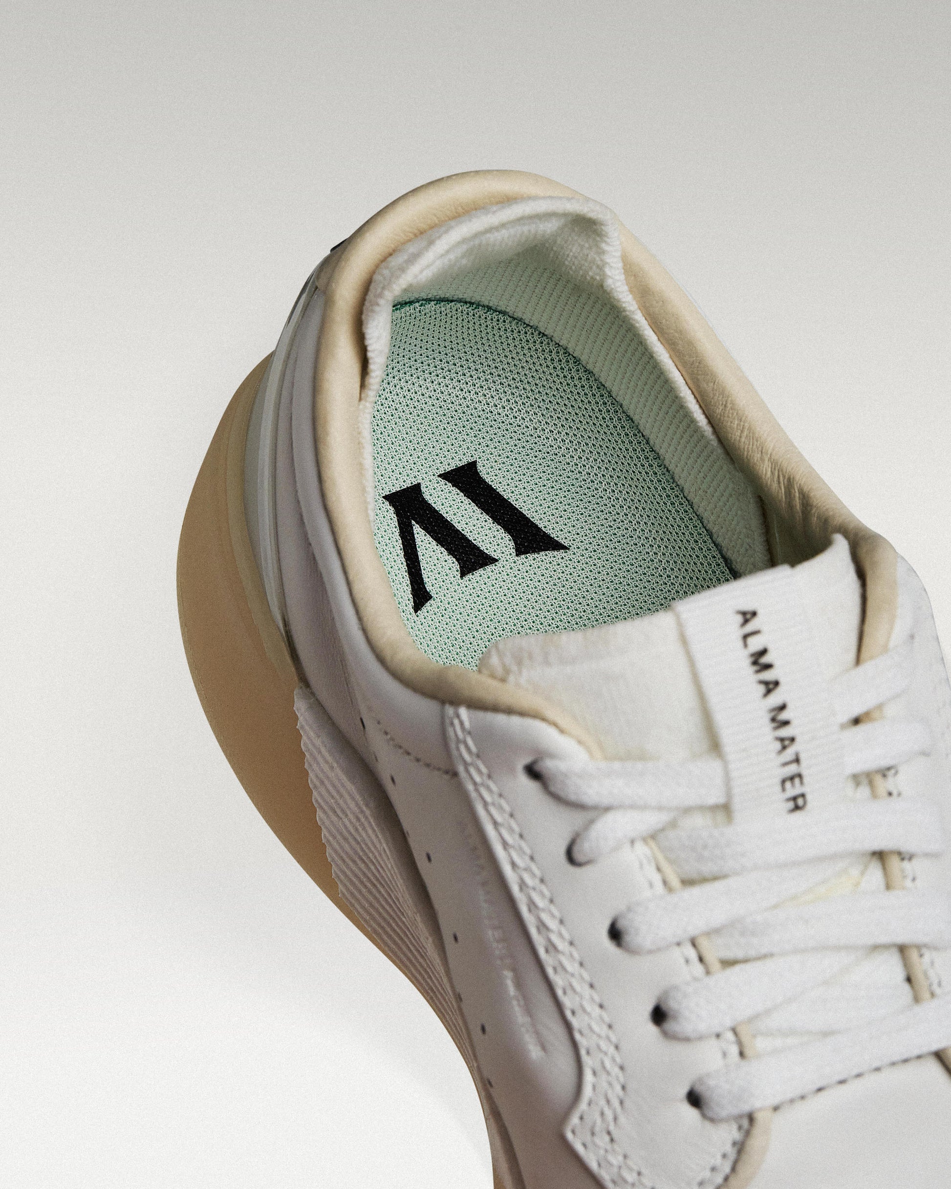 Close-up of interior lining and insole with logo, showcasing floating fit system