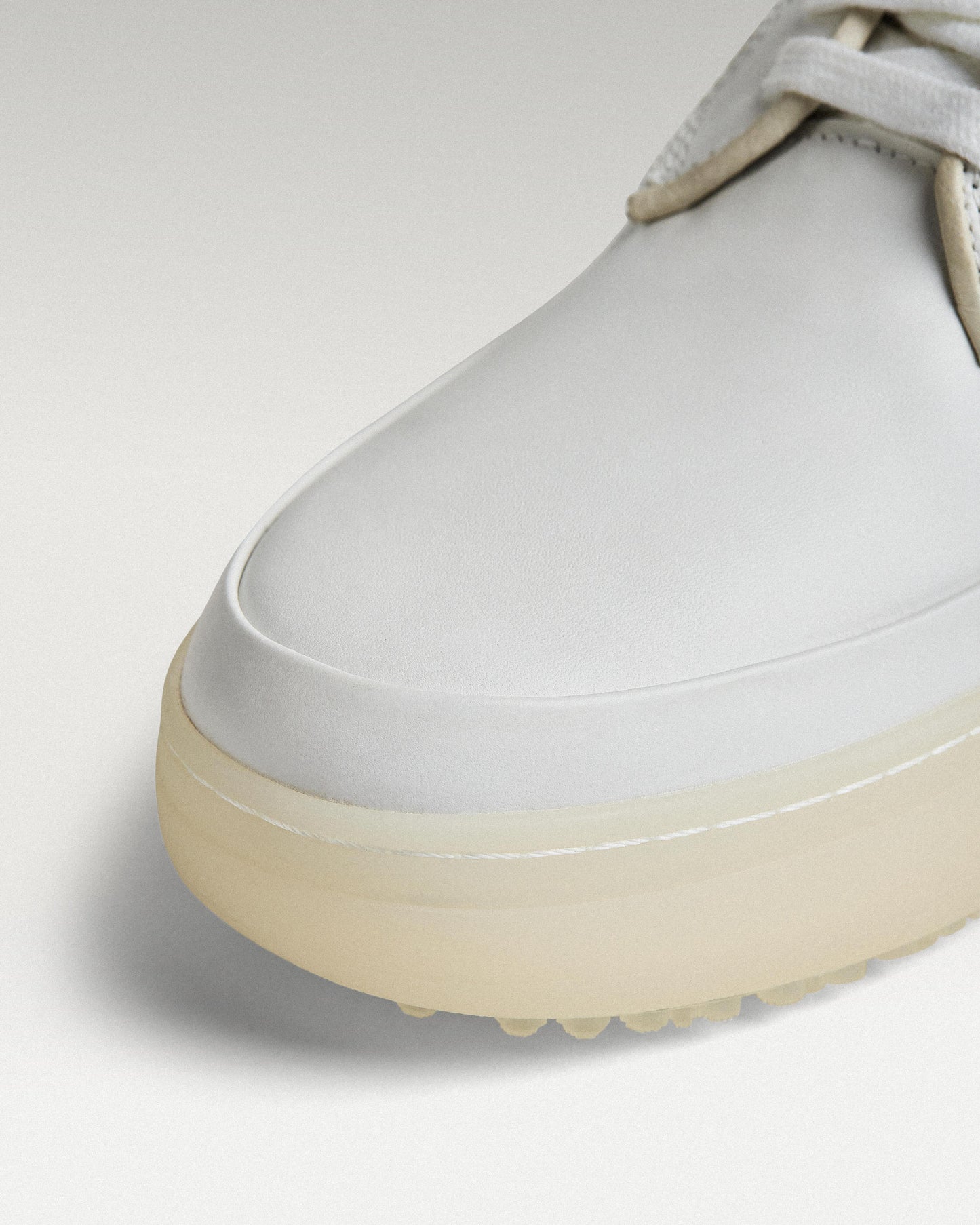 Close-up of white leather upper and toe box detail on Beta Derby golf shoe