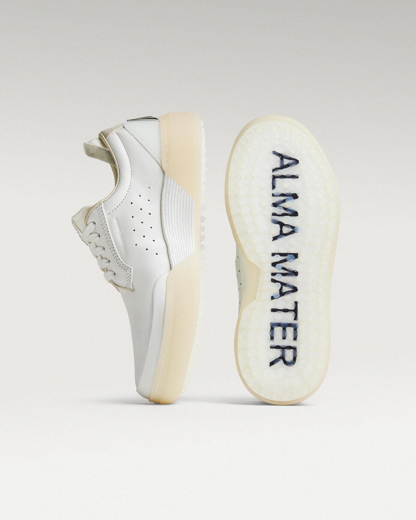 White and white Beta Derby golf shoe with outsole facing forward, showing traction pattern and logo