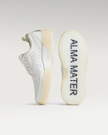 White and white Beta Derby golf shoe with outsole facing forward, showing traction pattern and logo