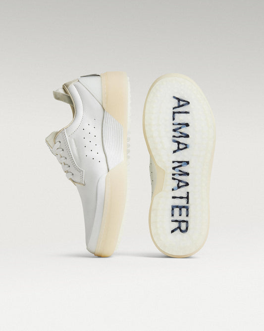 White and white Beta Derby golf shoe with outsole facing forward, showing traction pattern and logo