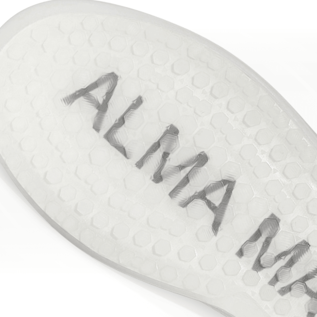 Macro close-up of the Women’s Beta Derby translucent spikeless outsole, showing hexagonal traction texture with subtle ALMA MATER branding embedded within the sole.