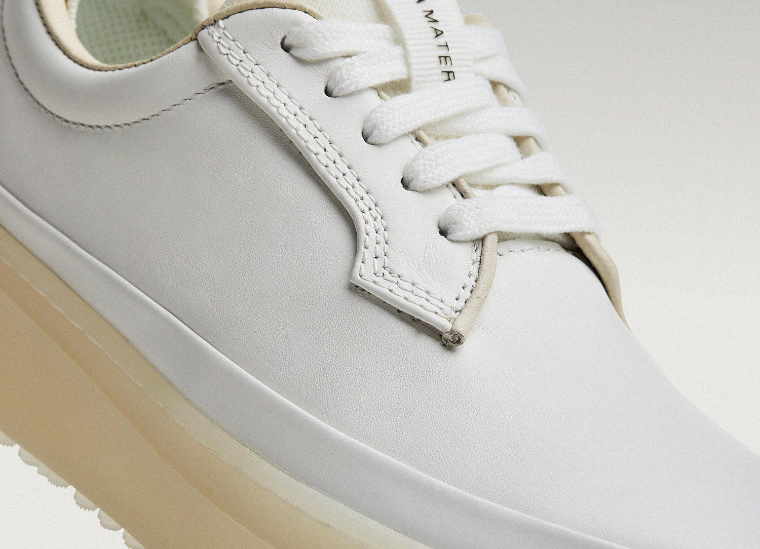 White Beta Derby sneaker featuring smooth leather upper, stitching detail, and lace-up closure