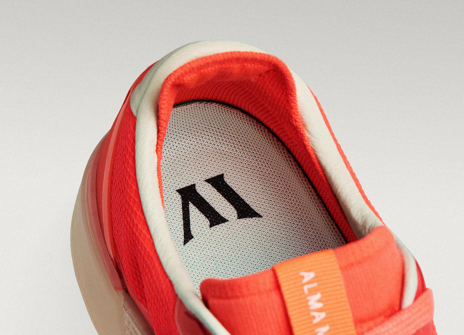Close-up of a Beta Lite Flare/Old Rose with a green insole featuring a logo on a light gray background.