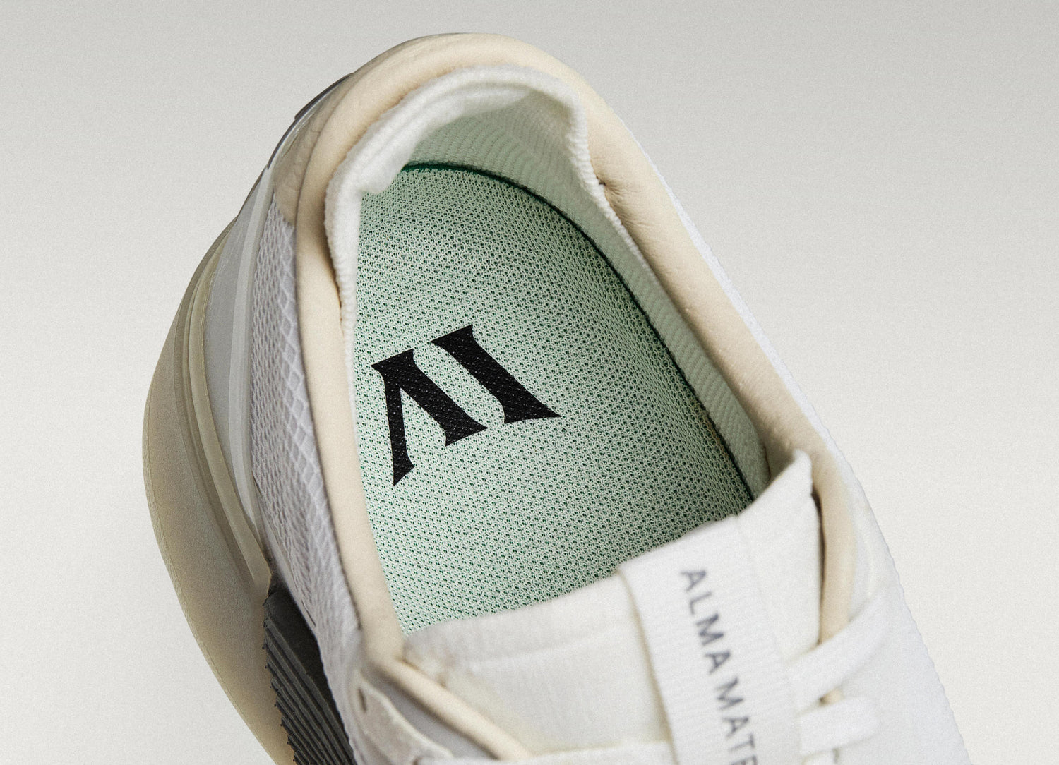 Close-up of a Beta Lite with a light green insole featuring a logo on a light gray background.