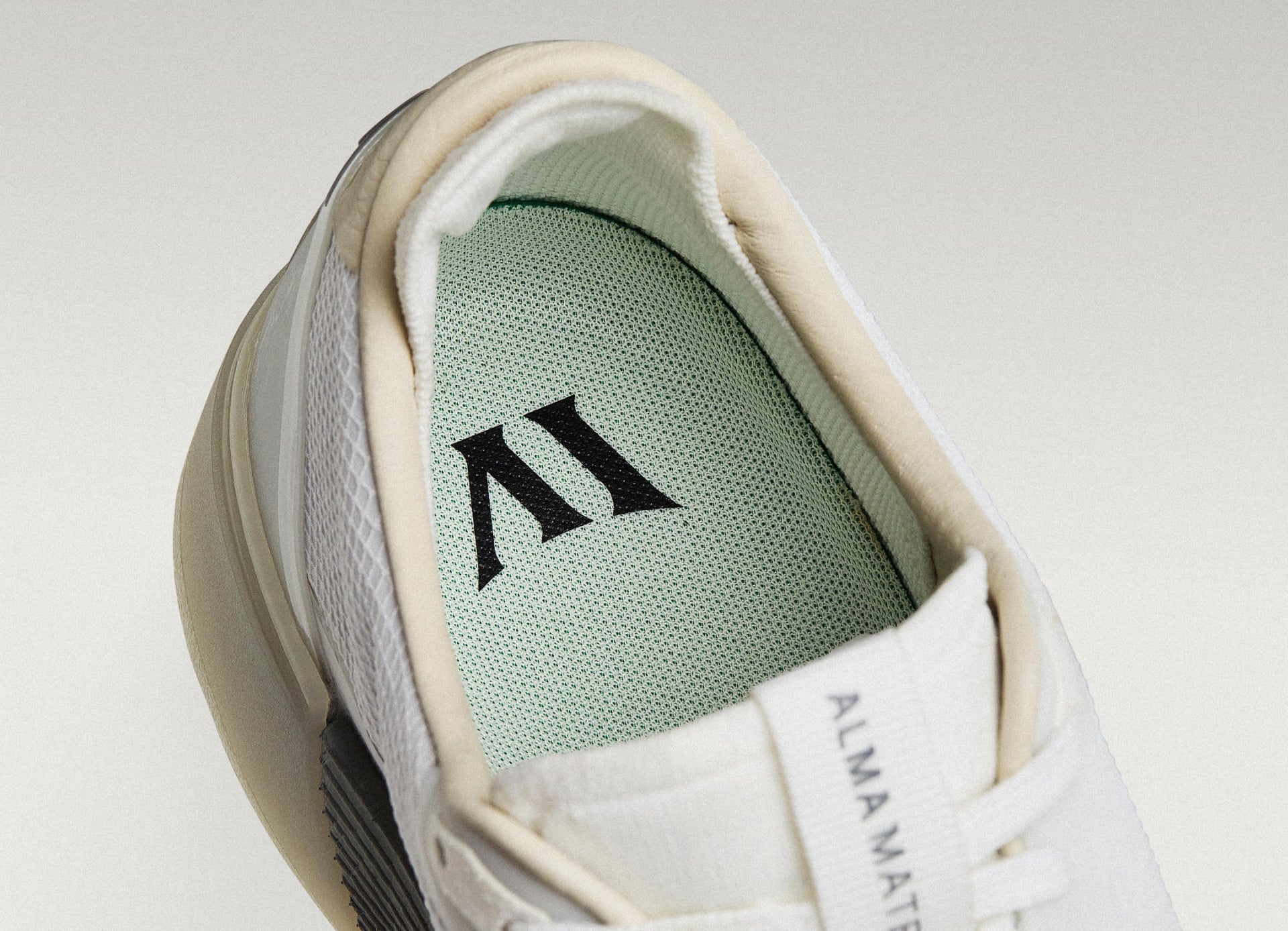 Close-up of a Beta Lite with a light green insole featuring a logo on a light gray background.