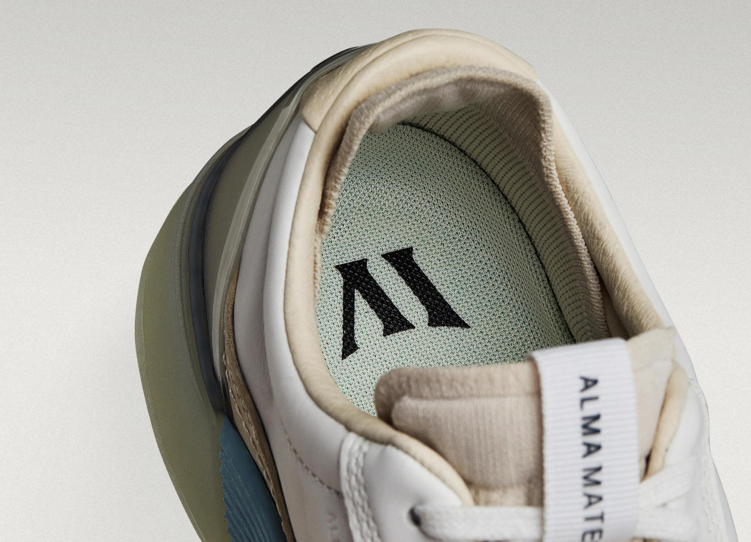 White/Navy Beta Longwing sneaker with visible Alma Mater logo and cushioned interior, highlighting floating fit system