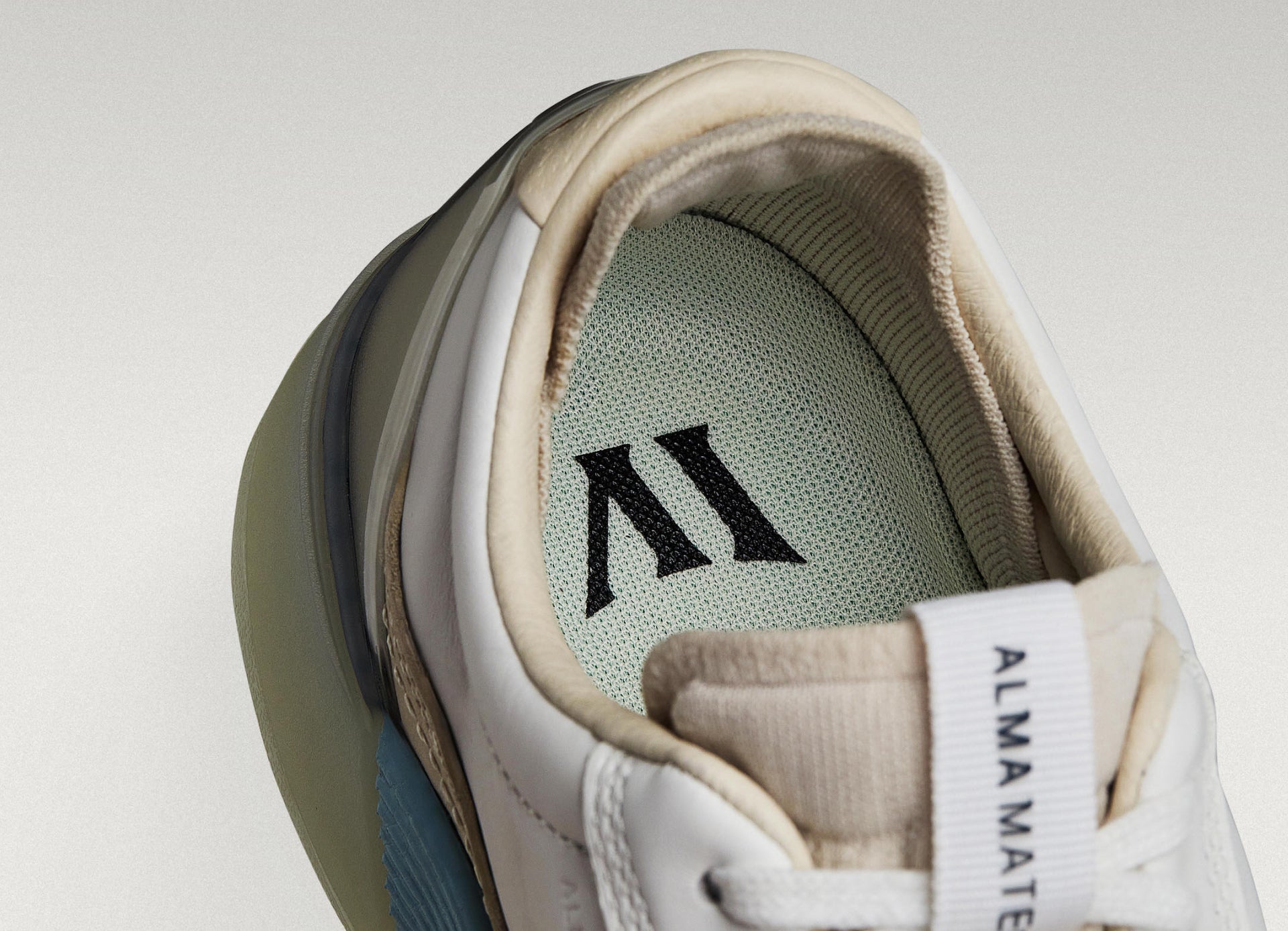 White/Navy Beta Longwing sneaker with visible Alma Mater logo and cushioned interior, highlighting floating fit system